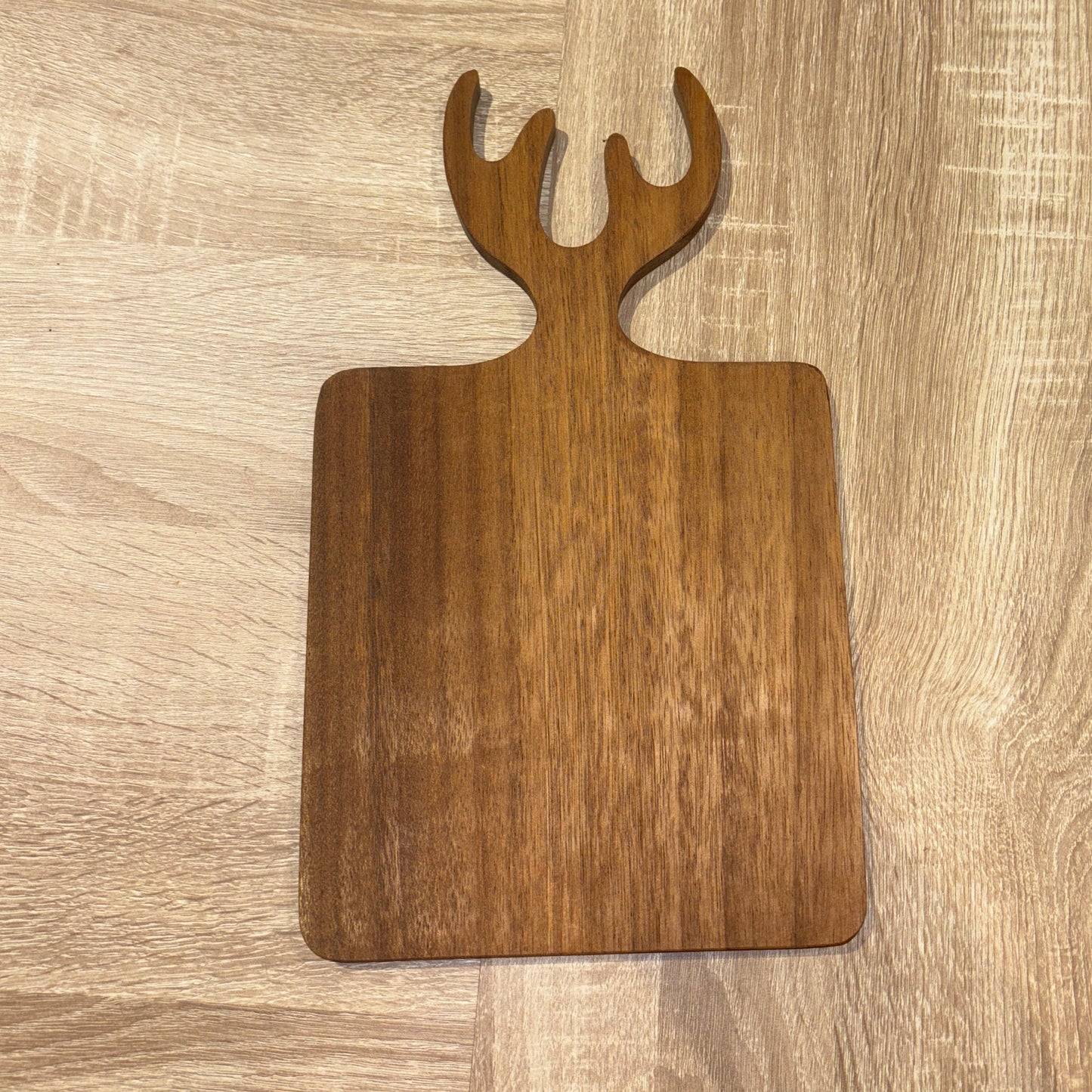 Wooden cutting board with a unique design on a wooden surface