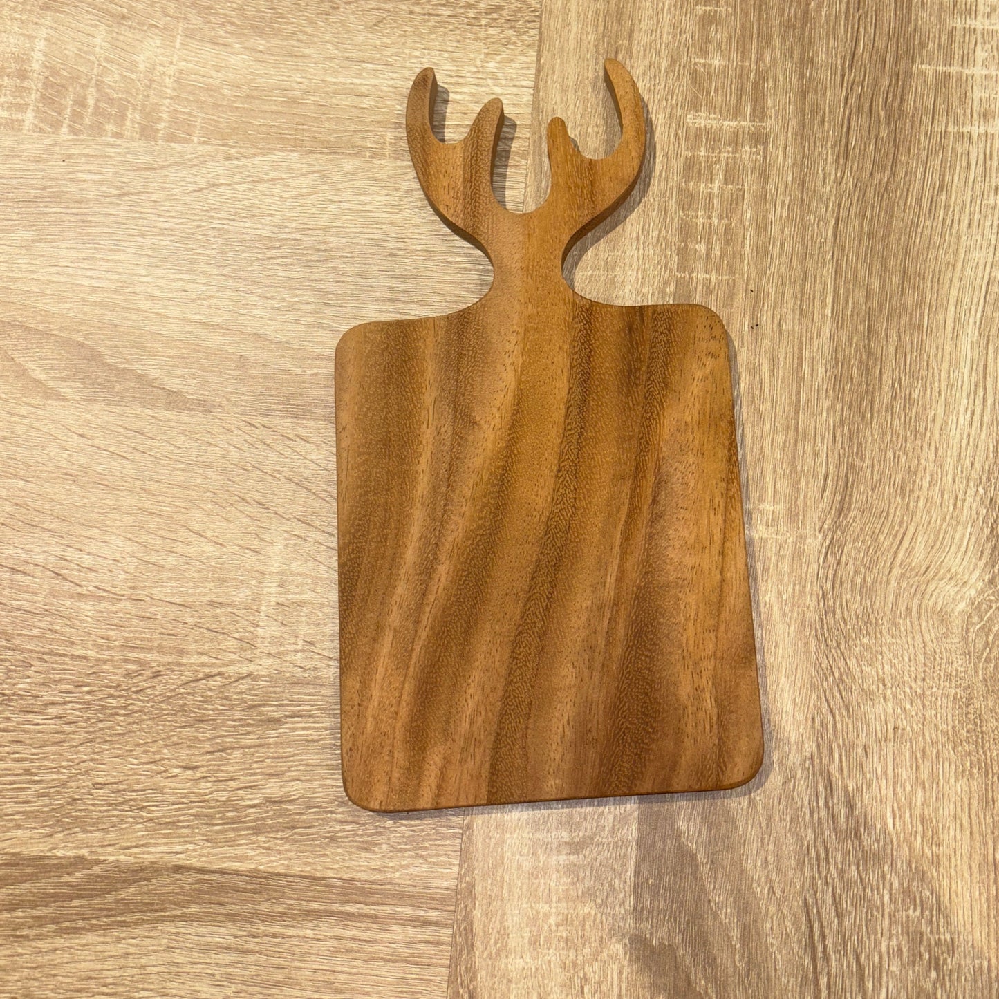 Wooden cutting board with a unique design on a wooden surface