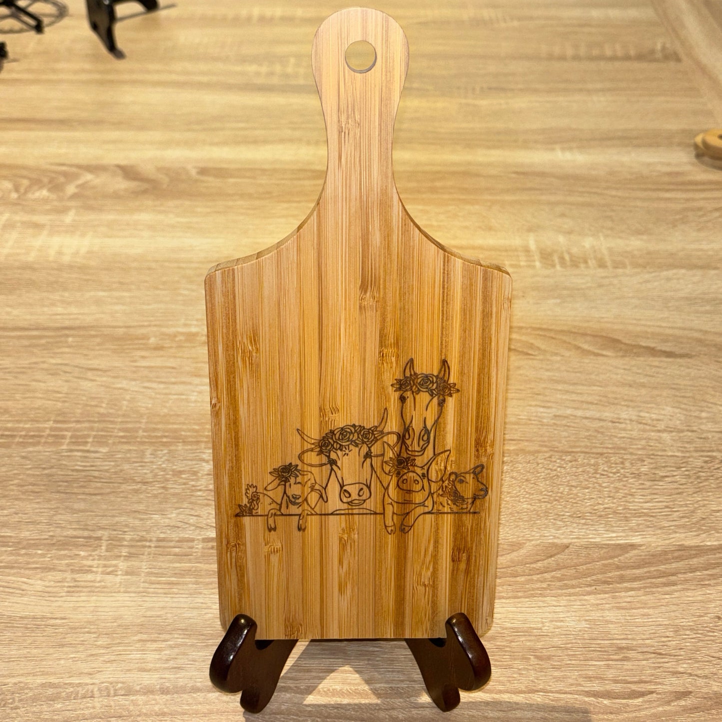 Wooden cutting board with engraved design on a wooden surface