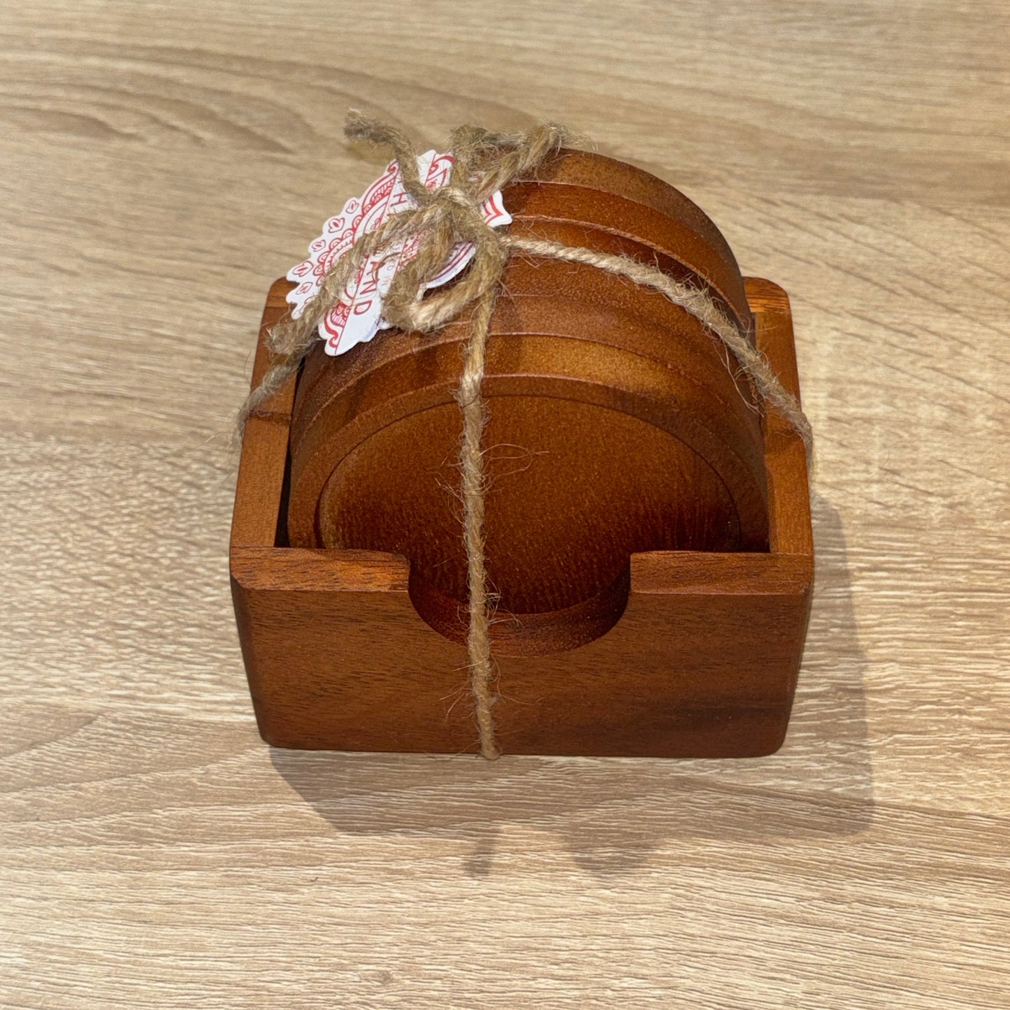Wooden coaster set with string on a wooden surface