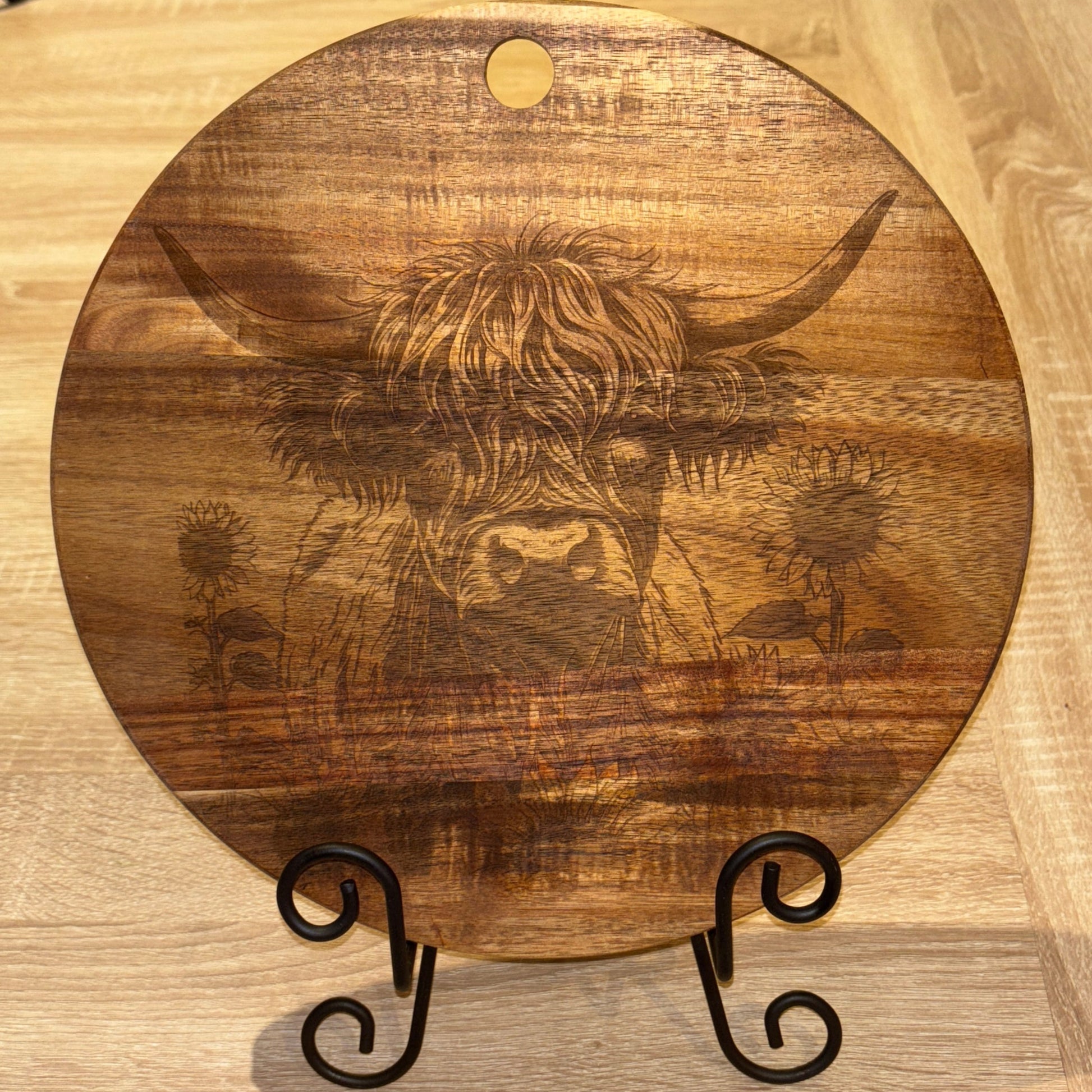 Wooden cutting board with engraved design on a wooden surface