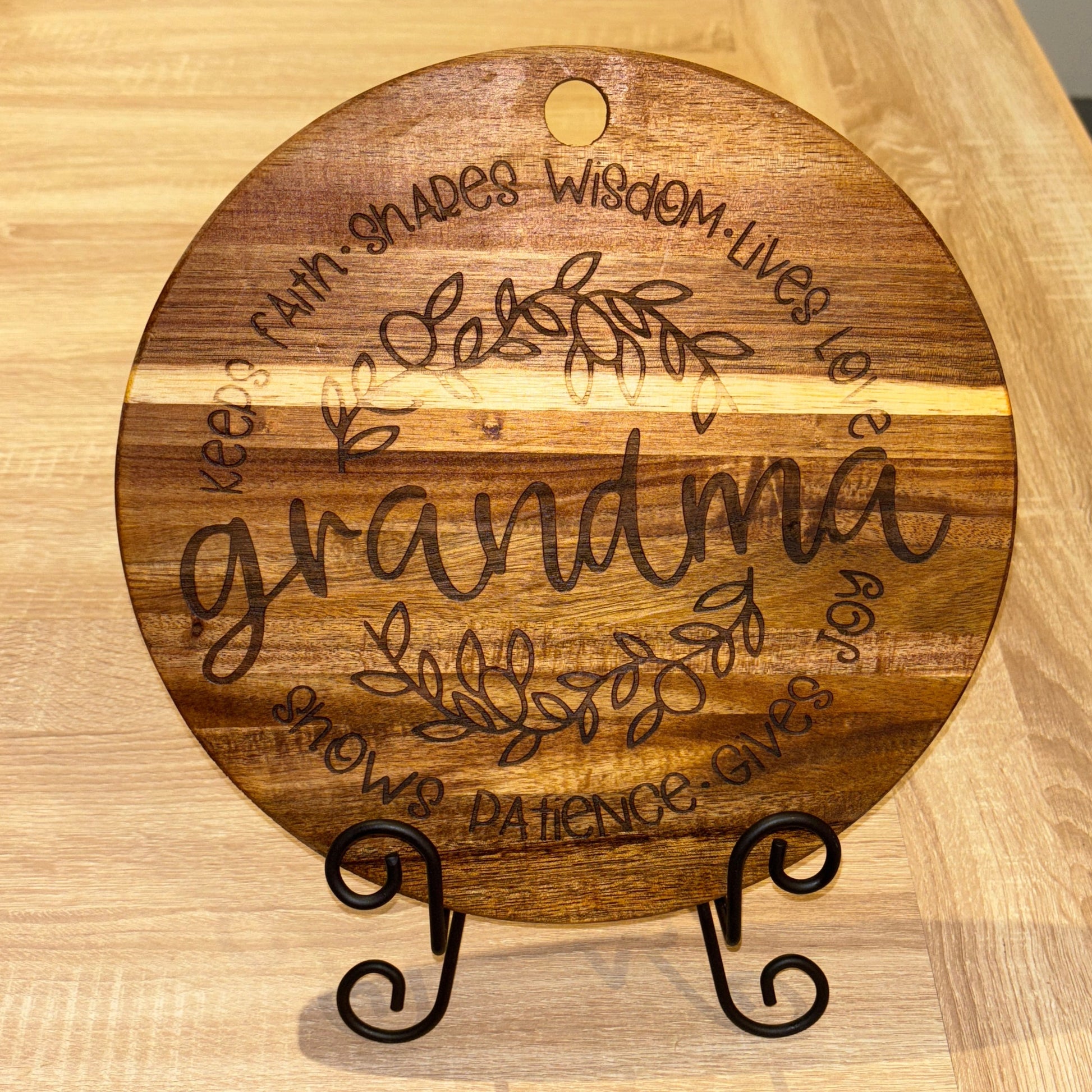Wooden cutting board with engraved text on a wooden surface