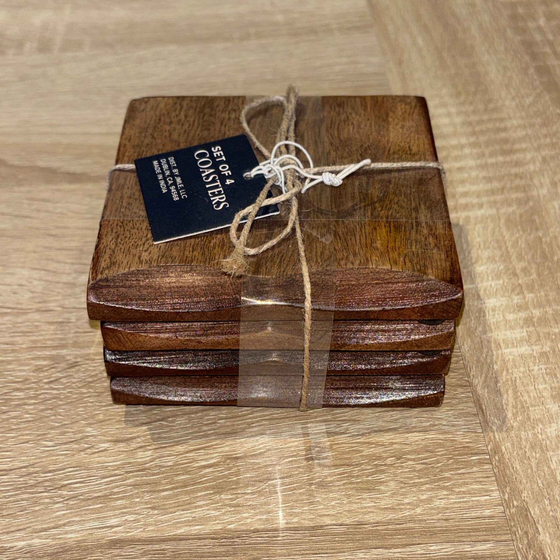 Set of wooden coasters with a tag on a wooden surface