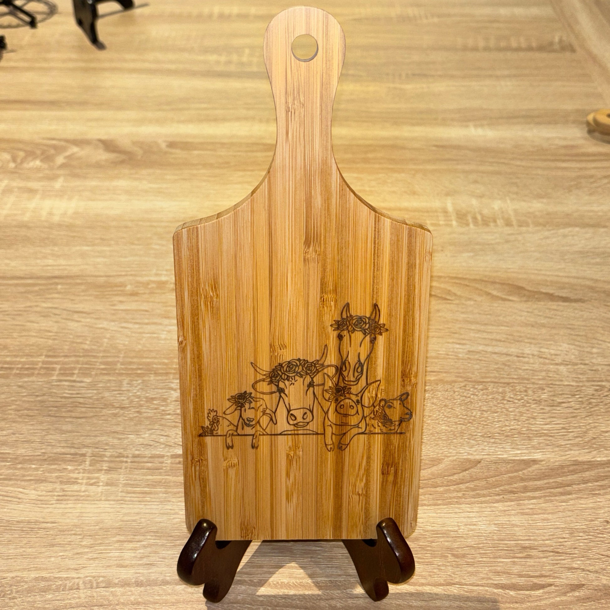 Wooden cutting board with engraved design on a wooden surface